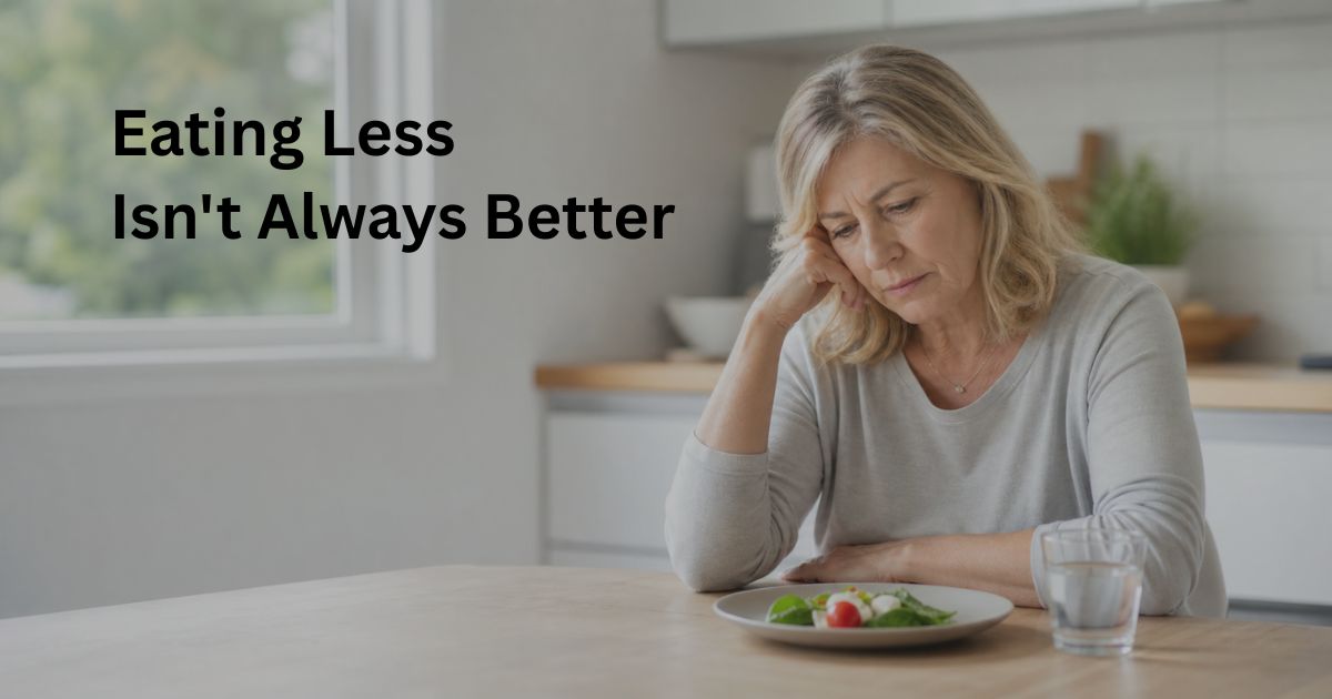 Woman over 50 looking at a very small meal, illustrating how eating too little may affect metabolism, energy levels, and muscle maintenance after age 50.